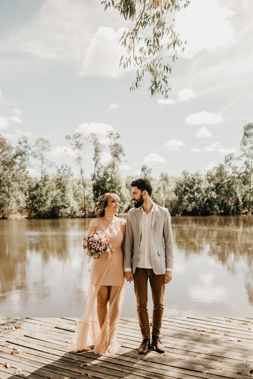 man standing beside woman